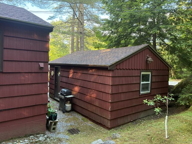 Shingle roofing on a red outbuilding