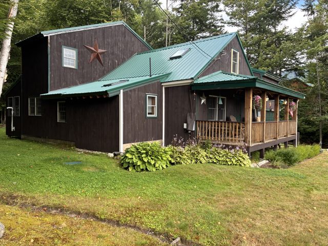 Green metal roofing on a wood-sided home